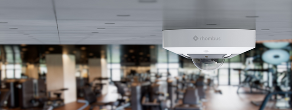 A Rhombus R360 Fisheye Security Camera mounted on the ceiling in a gym.